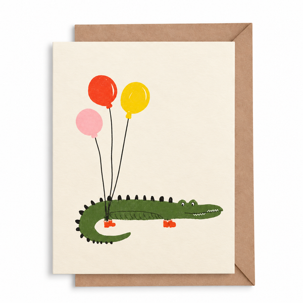 Postal cocodrilo con tres globos y sobre kraft