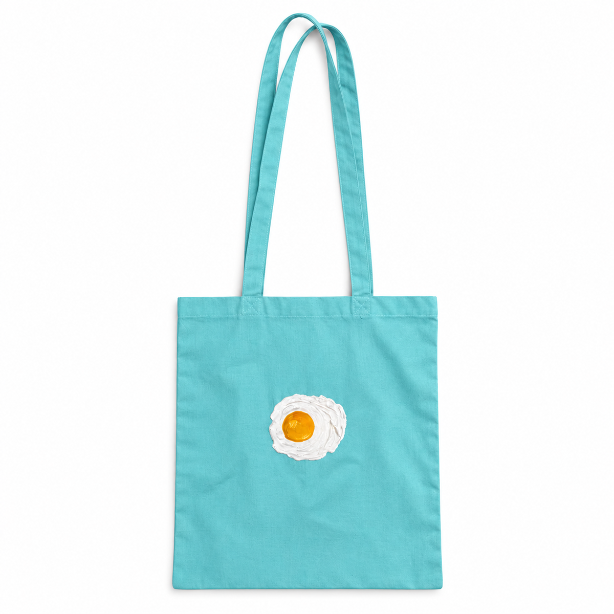 Tote bag Turquesa con 1 huevos fritos en relieve sobre fondo blanco