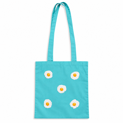 Tote bag Turquesa con 5 huevos fritos en relieve sobre fondo blanco